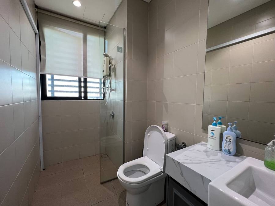 Bathroom with a walk-in shower, toilet with bidet spray, and a basin.