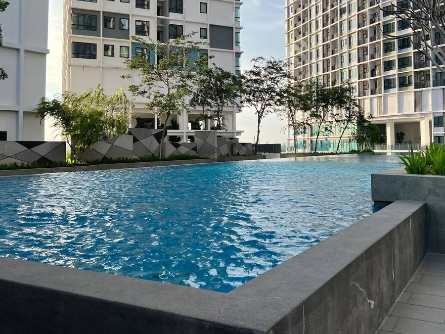 The shared outdoor swimming pool in the building, with the towers rising behind it.
